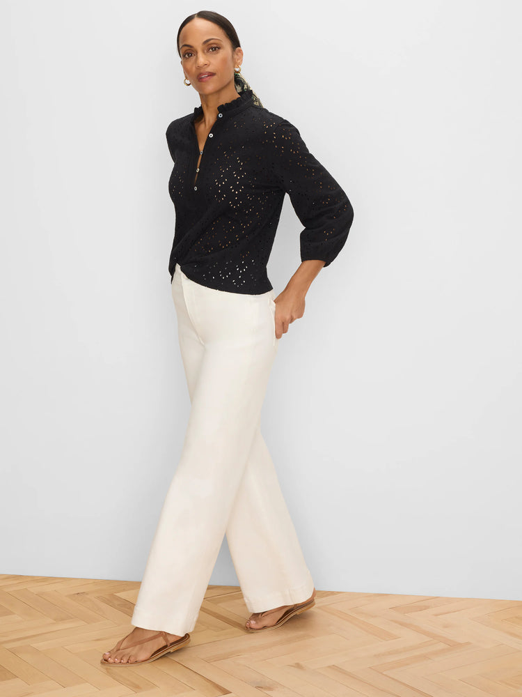 Black eyelet top with a ruffle neck and 3/4 length sleeves.