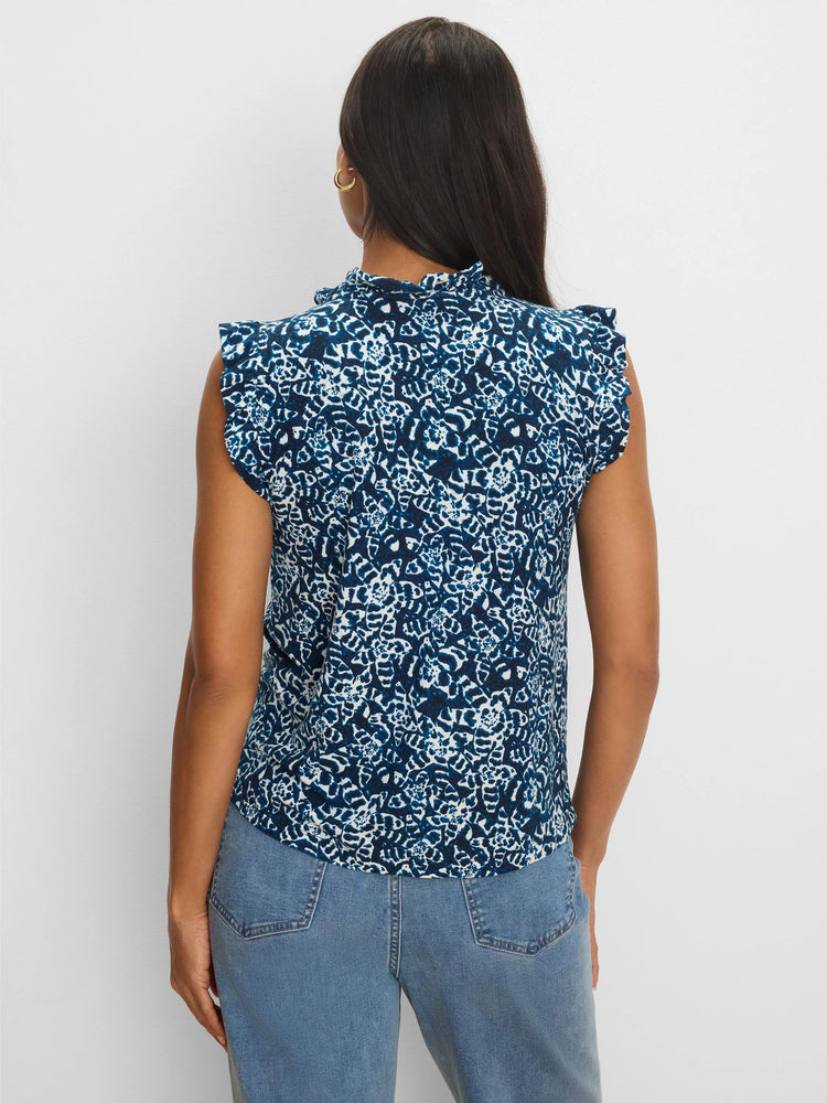 Dark blue & white shibori-patterned top with a ruffled mock neck and ruffled cap sleeves, shown from the back.