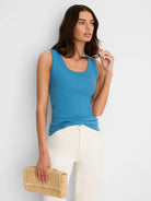 Close-fitting bright blue ribbed scoop tank top on a model.