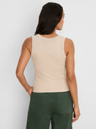 Light beige ribbed knit tank, rounded back neckline.