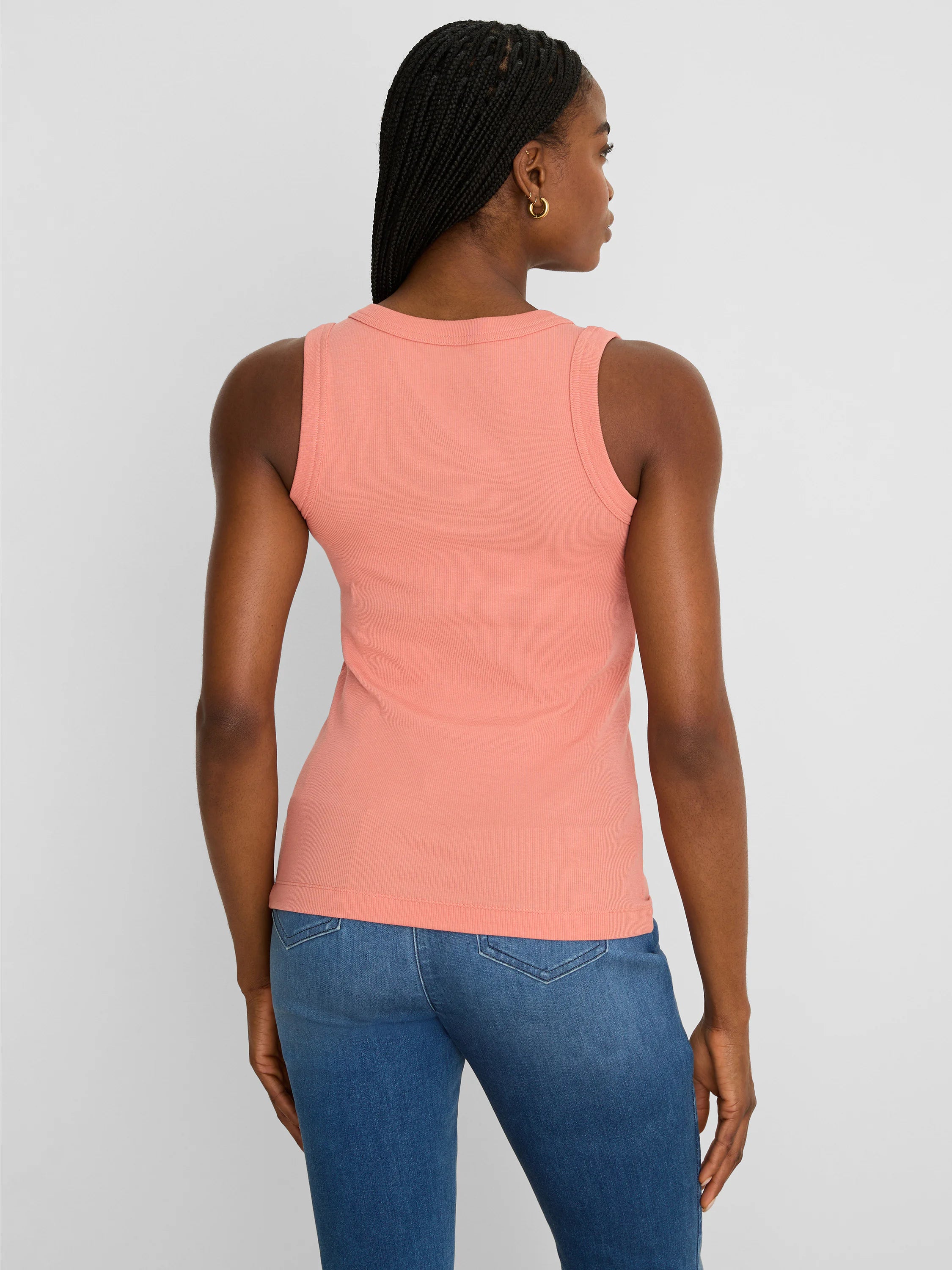 Peach ribbed scoop tank top on model, back view. Fitted style.