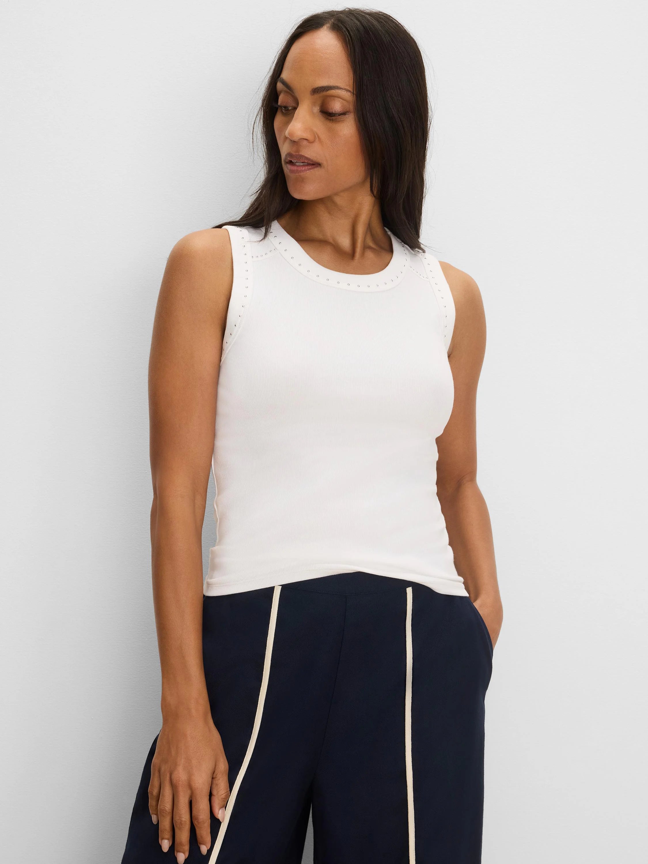 Cream rib knit tank with small silver studs along its round neckline and shoulders.
