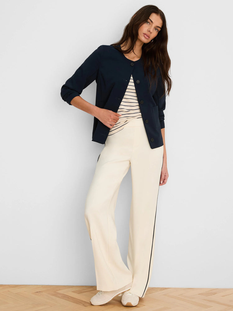 Dark blue collarless jacket with front buttons, 3/4 sleeves, and two front patch pockets.