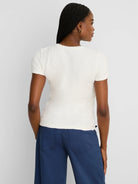 Off-white short-sleeve tee with a crinkled, puckered texture and round neck.