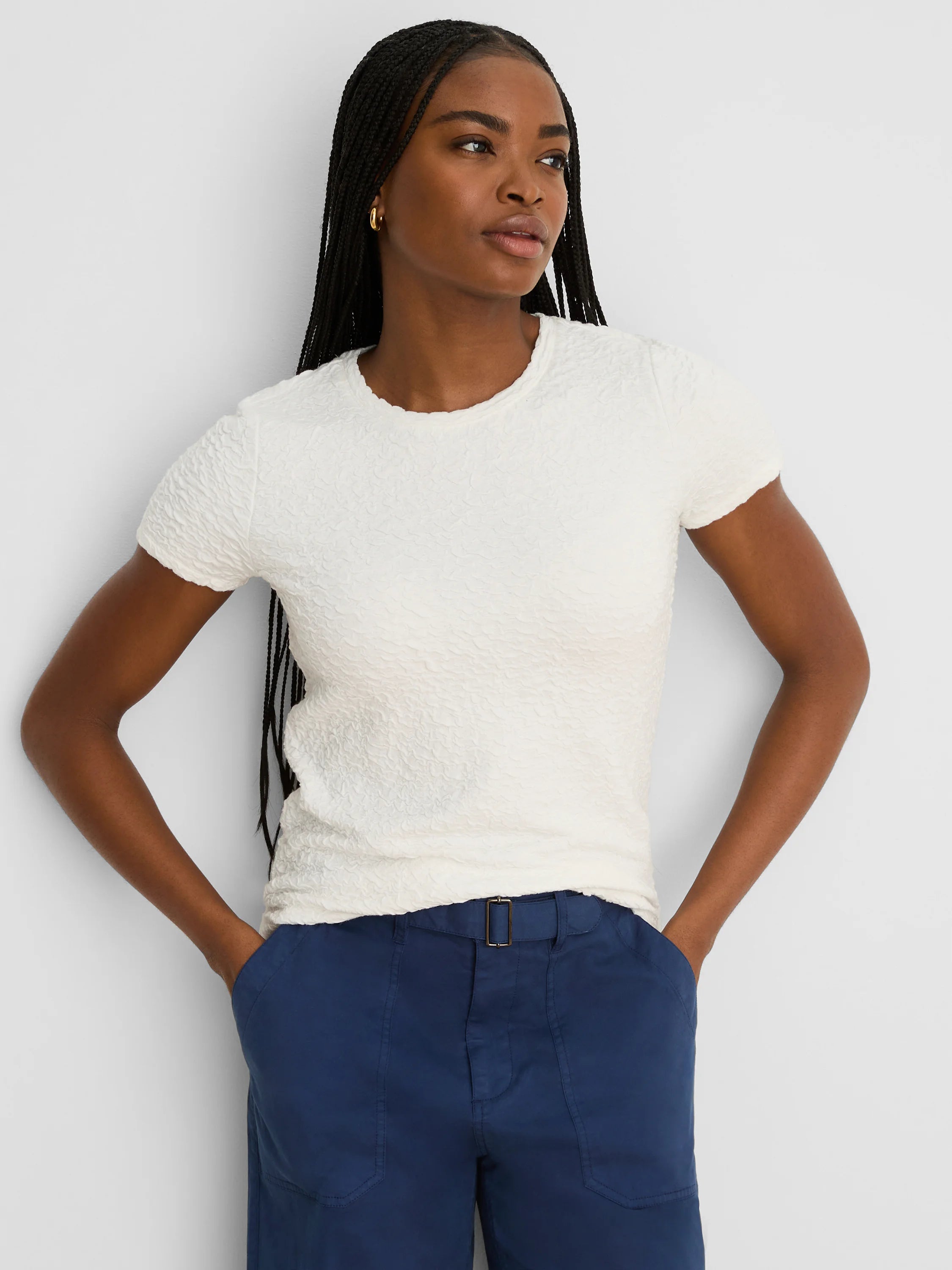 Off-white, short-sleeve crew neck tee with a distinct puckered texture.