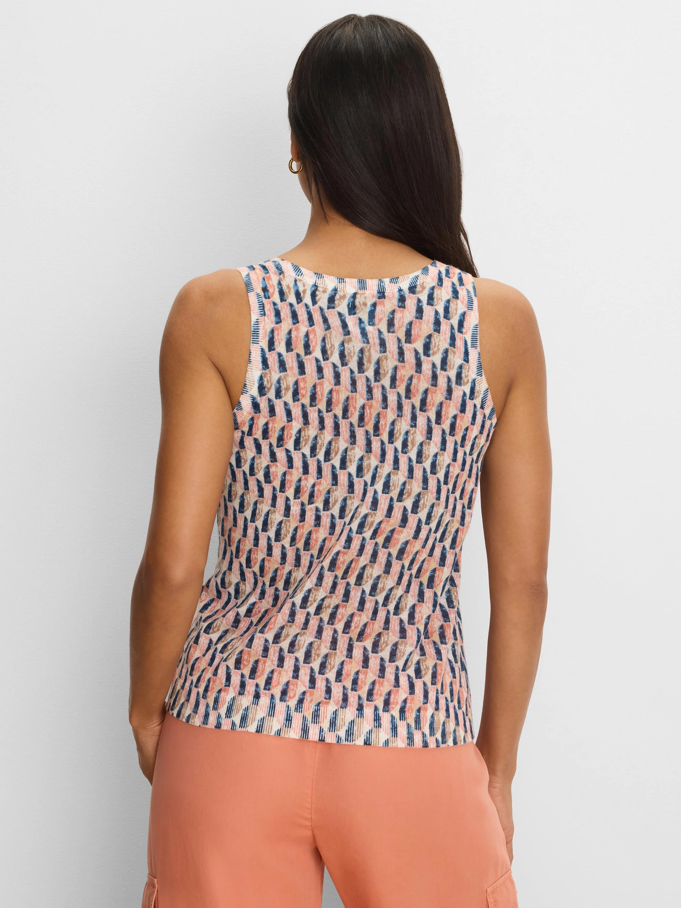 Sleeveless sweater tank with abstract navy, peach, and tan brushstroke pattern on a cream background.