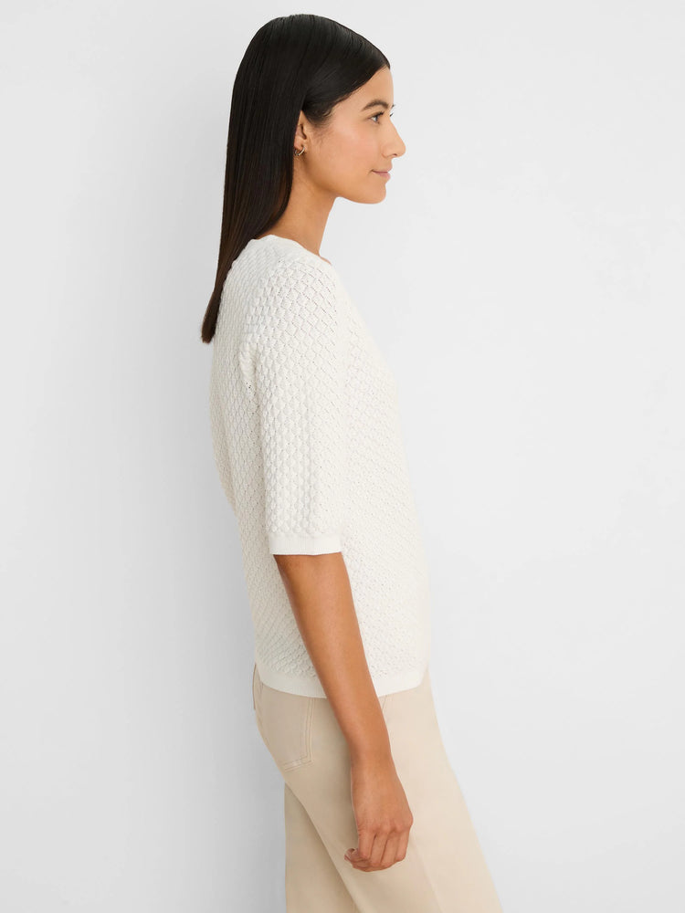 Cream scallop knit sweater tee with elbow-length sleeves, ribbed cuffs and hem.