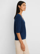 Dark blue V-neck sweater tee with prominent scallop texture and elbow sleeves.