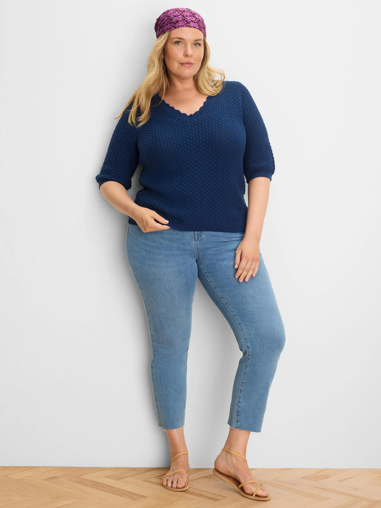 Dark blue sweater tee with an all-over textured knit, scalloped neckline, and elbow-length sleeves.