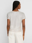 Shimmery champagne short-sleeve featherknit sweater, shown from the back on a model.
