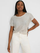 Shimmery light beige featherknit sweater with a loose fit, short sleeves, and crew neck.