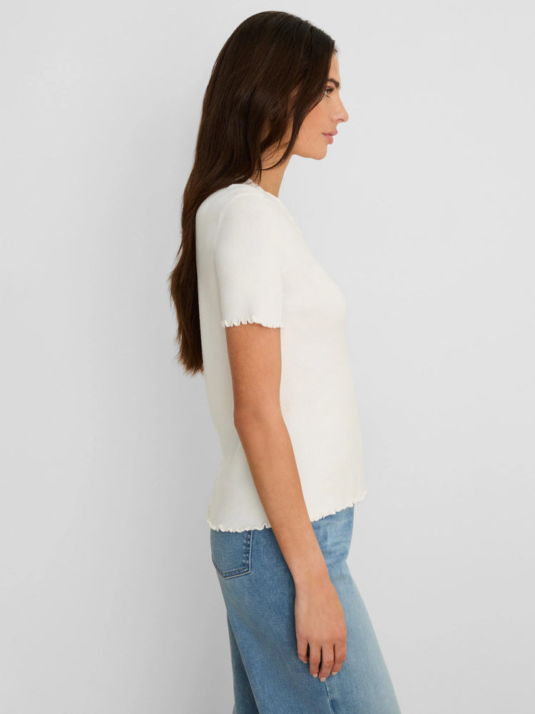 Cream ribbed short sleeve top with ruffle trim on the cuffs and hem.