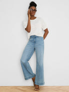 Off-white short-sleeve sweater with a textured, open-knit swirl pattern.