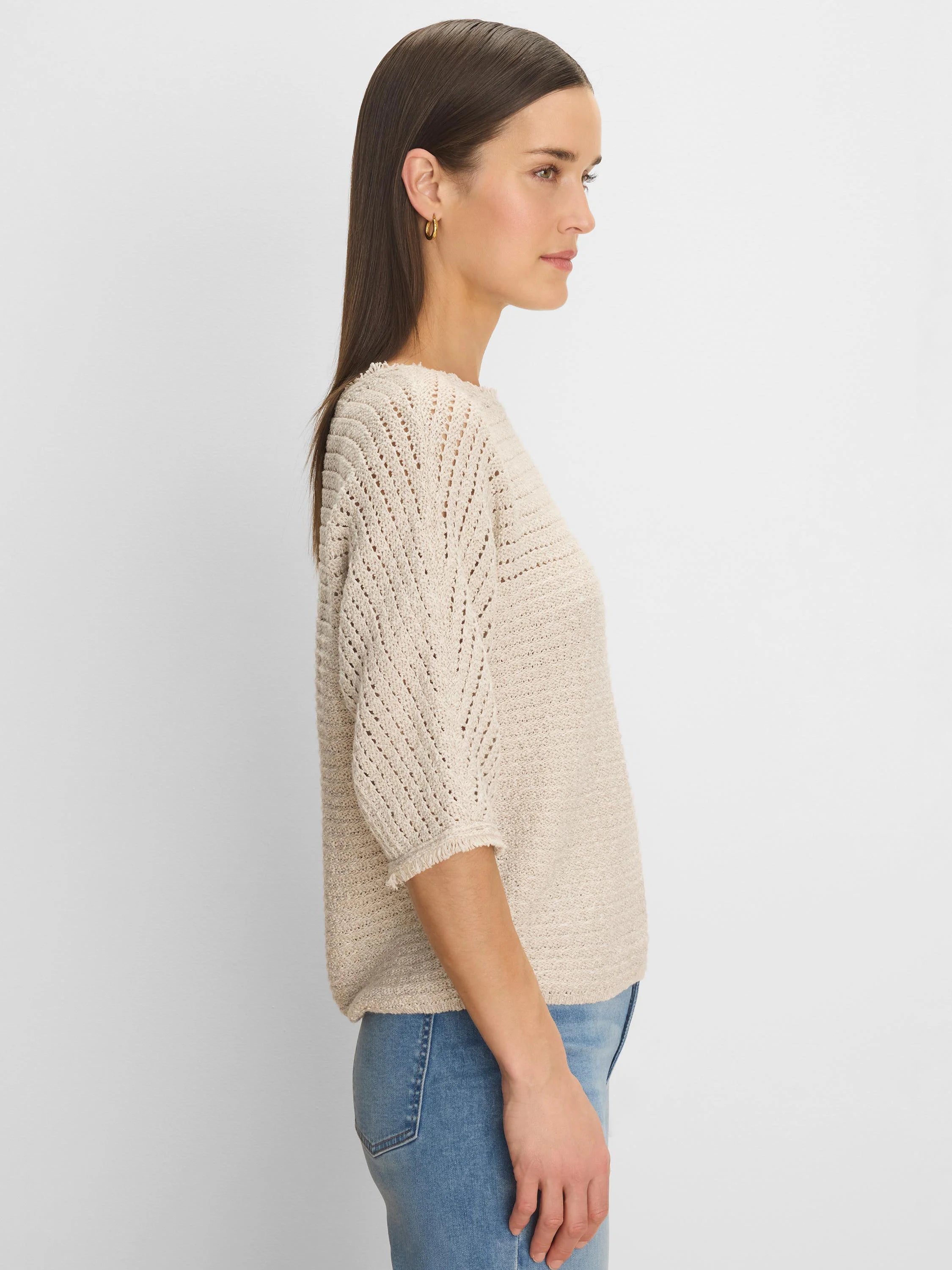 Light beige tonal texture sweater. Features include open knit patterns on shoulders/sleeves & fringed 3/4 cuffs.