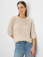 Oatmeal open-knit sweater with tonal textures, frayed neckline & 3/4 sleeves with frayed cuffs.