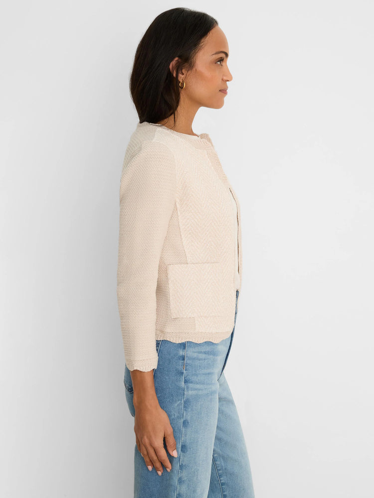Light beige knit jacket with chevron weave pattern, scallop trim on hem and cuffs, round neck, and patch pockets.