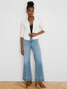 Cream textured knit jacket with elbow sleeves, collar, and front buttons.