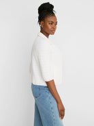 White elbow-sleeve textured knit jacket with a collar.