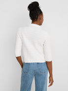 White textured knit jacket with elbow sleeves and collar, worn from behind.