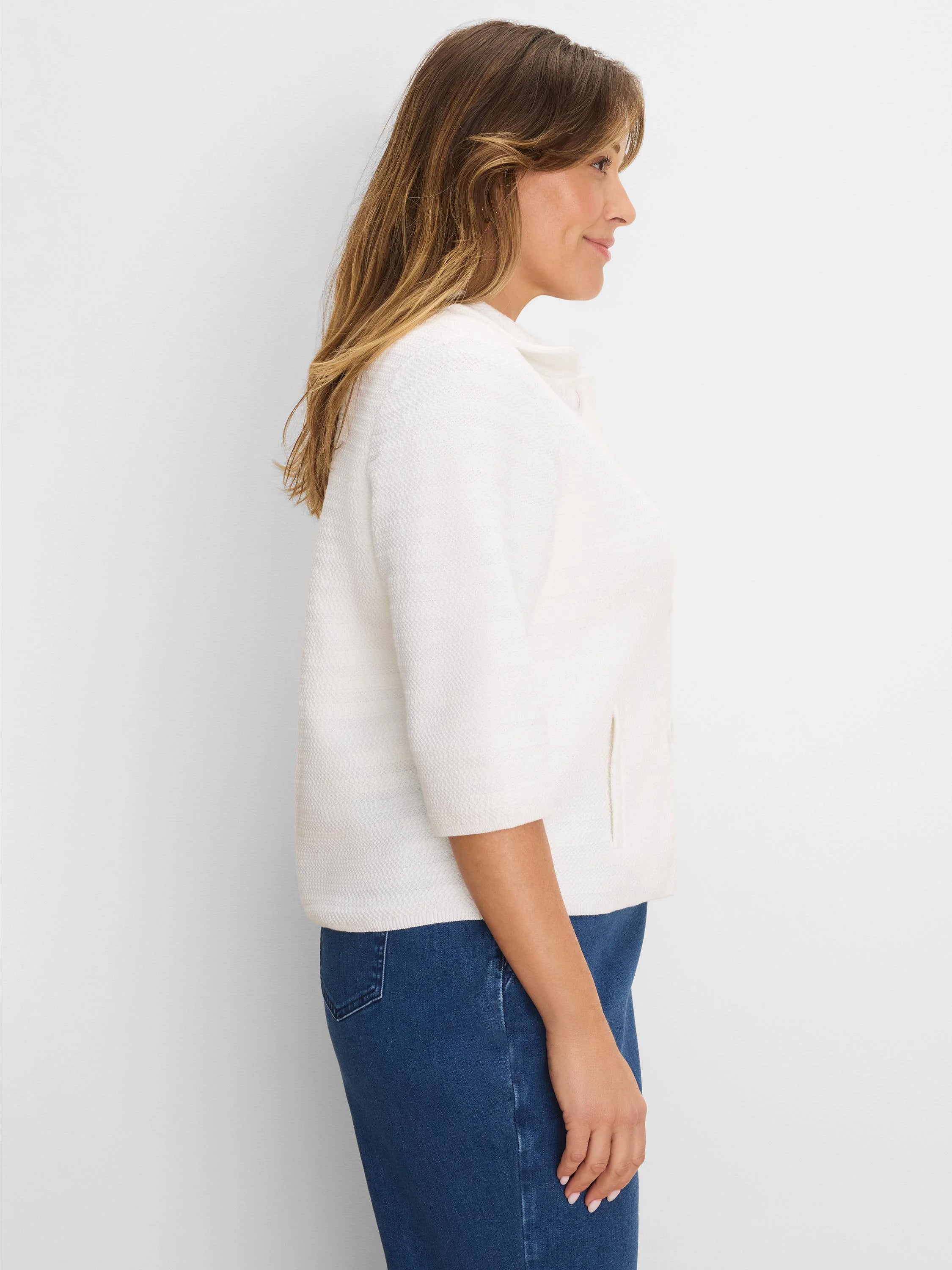 Cream textured knit jacket with elbow sleeves, band collar, and subtle side pockets.
