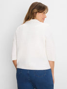 White textured knit jacket with elbow sleeves and a collar, shown from the back.