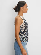 Light beige knit tank with indigo and light blue abstract brushstroke pattern. Ribbed trim.