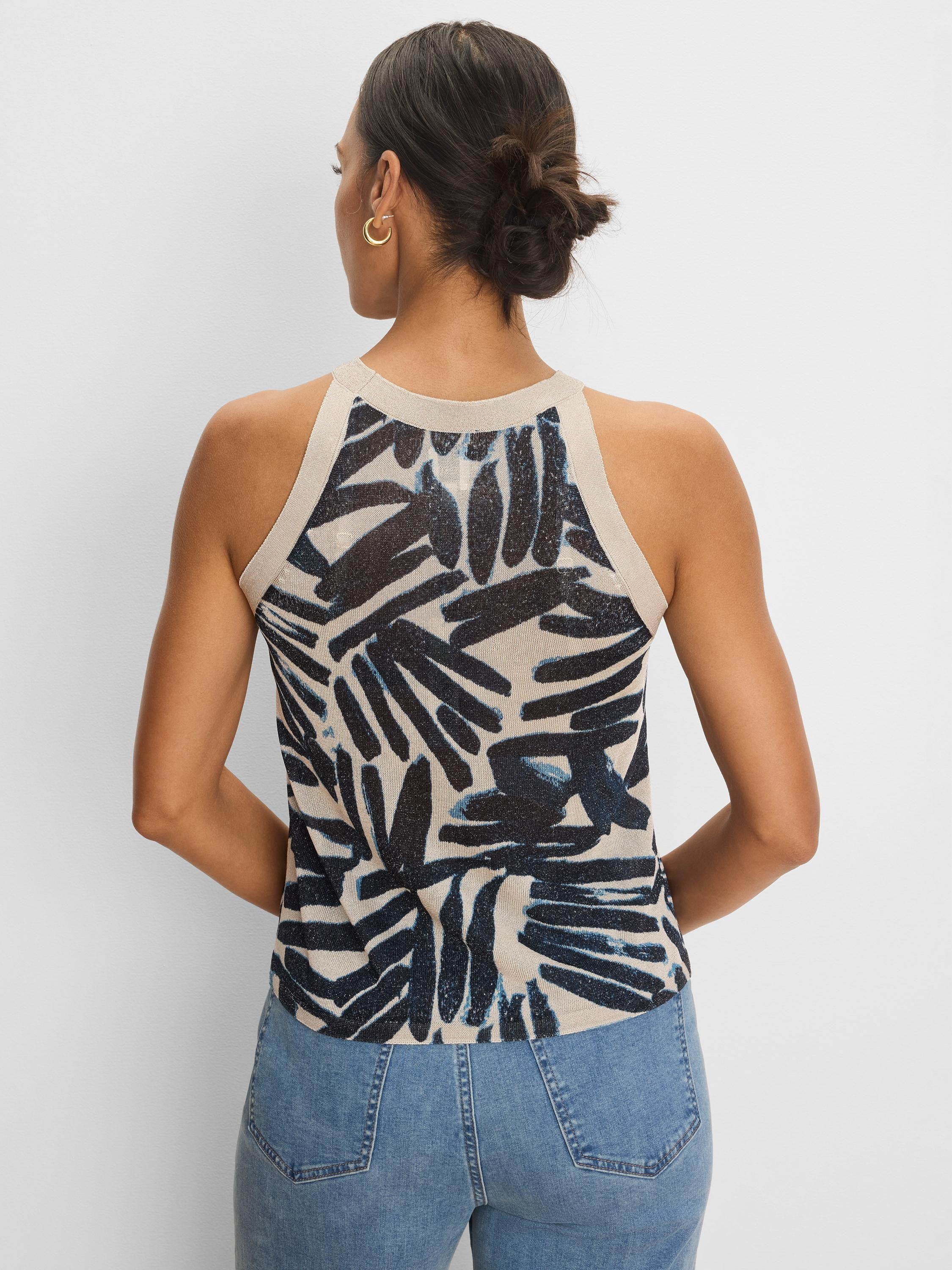 Beige knit tank with dark blue painted palm pattern. Ribbed beige neck and armholes. Back view.