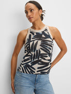 Light beige knit tank with a high neckline. Features an abstract dark blue and light blue palm-like pattern.