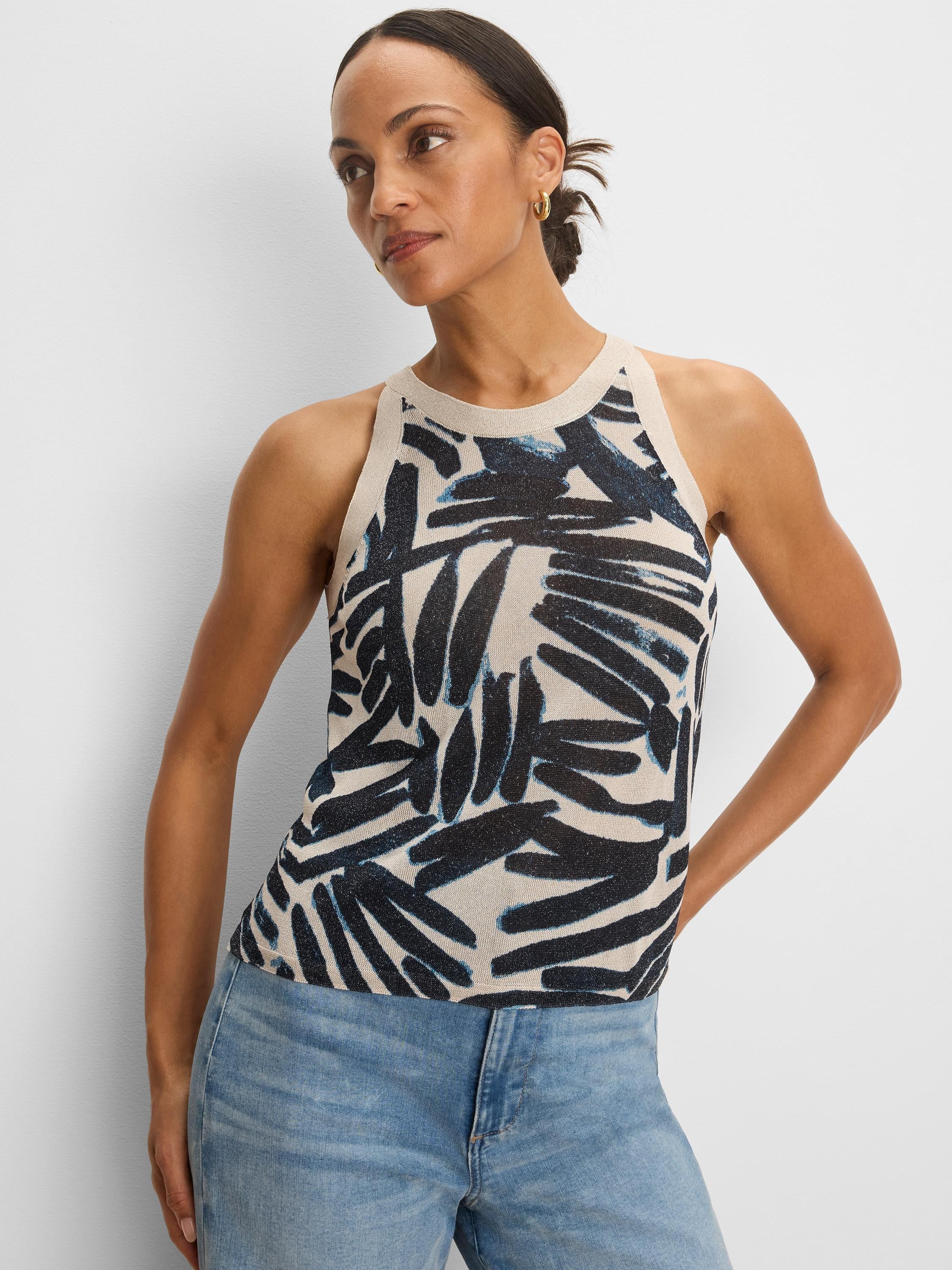 Light beige knit tank with a high neckline. Features an abstract dark blue and light blue palm-like pattern.