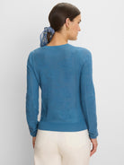 Teal blue long-sleeved jacquard lace sweater with an all-over tonal floral pattern and ribbed trim.