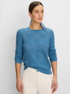 Teal blue sweater featuring a subtle floral jacquard knit.