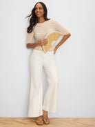Light beige crochet sweater with horizontal tan stripes and elbow-length sleeves.