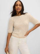 Cream and tan crochet sweater with horizontal stripes, boat neck, and elbow-length sleeves.