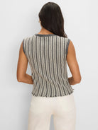 Sleeveless sweater with alternating cream & black vertical stripes, dark grey ribbed trim, and a frayed hem.