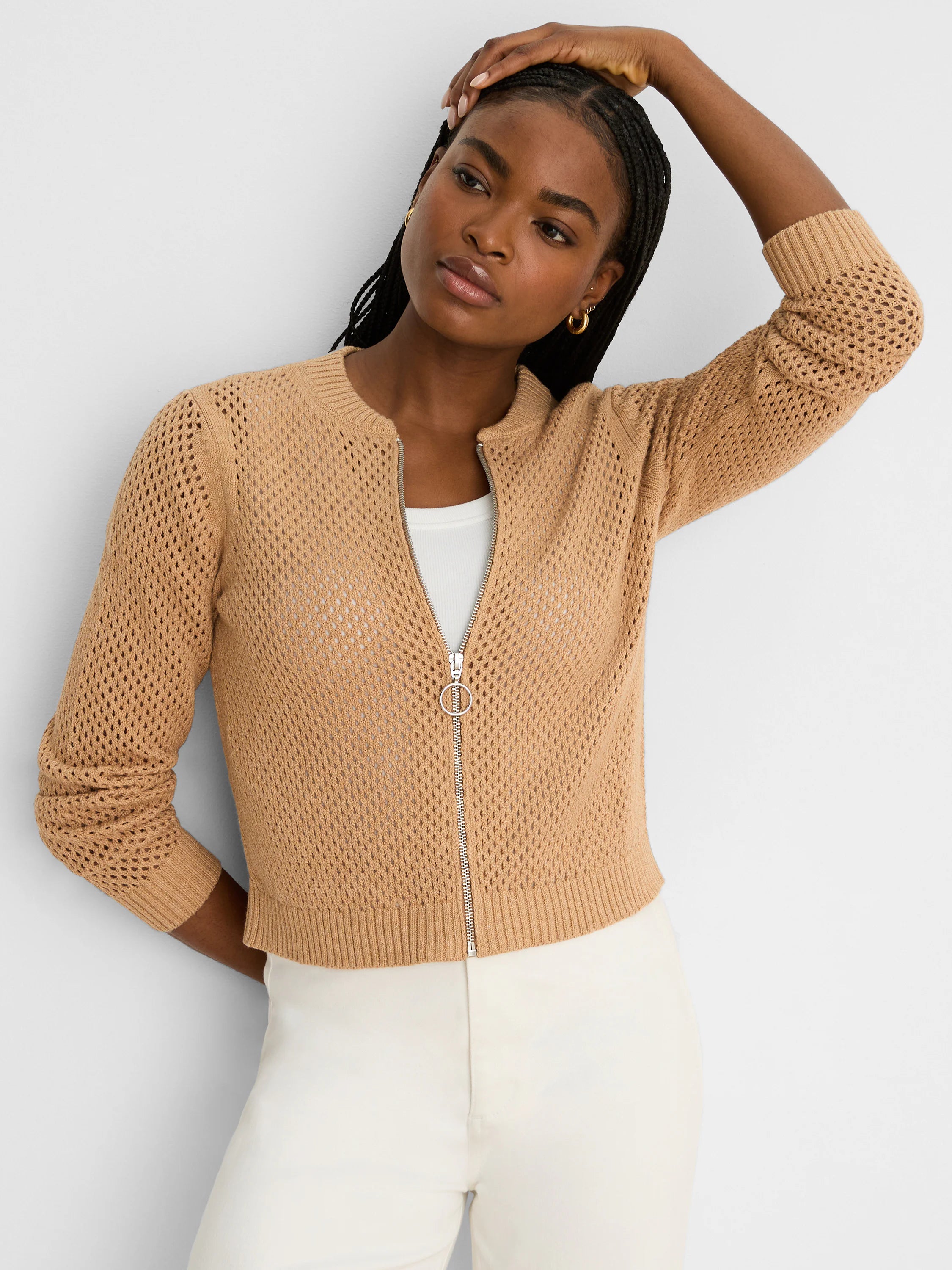 Tan mesh knit cardigan with ribbed trim. Features full silver zipper with a circular ring pull.