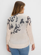 Light beige sheer knit long sleeve cardigan with dark blue iris and leaf pattern on back and shoulders.