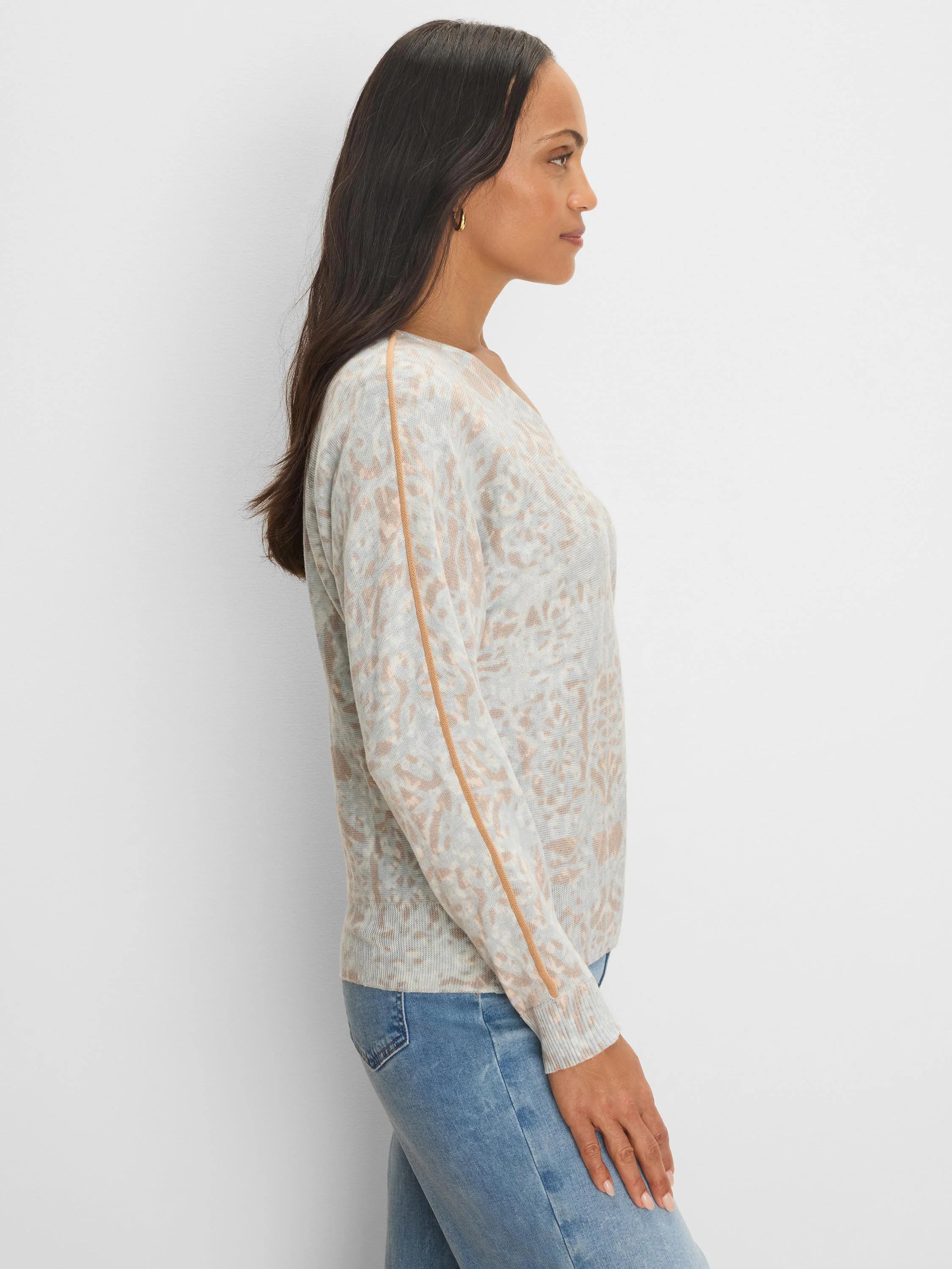 Gray v-neck sweater with mottled tan pattern and tan tipping stripes along outer sleeves.