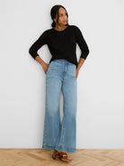 Black mesh sweater with long sleeves and a crew neck.