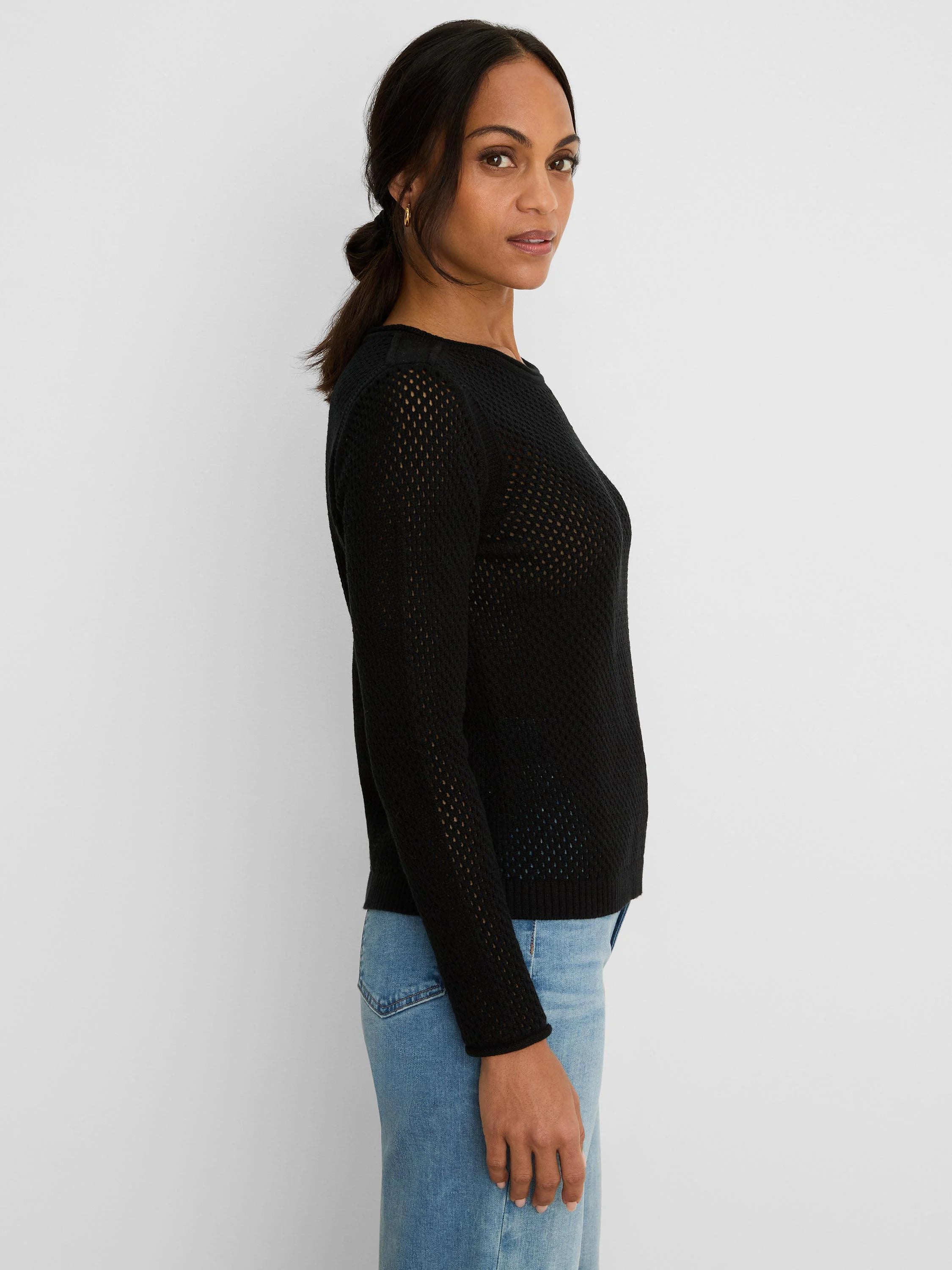 Black long-sleeve sweater with an open mesh knit, round neck, and ribbed cuffs/hem.