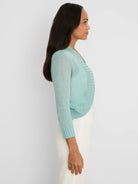 Aqua cropped bolero cardigan with a sheer, fine knit texture, open front, and ribbed cuffs.