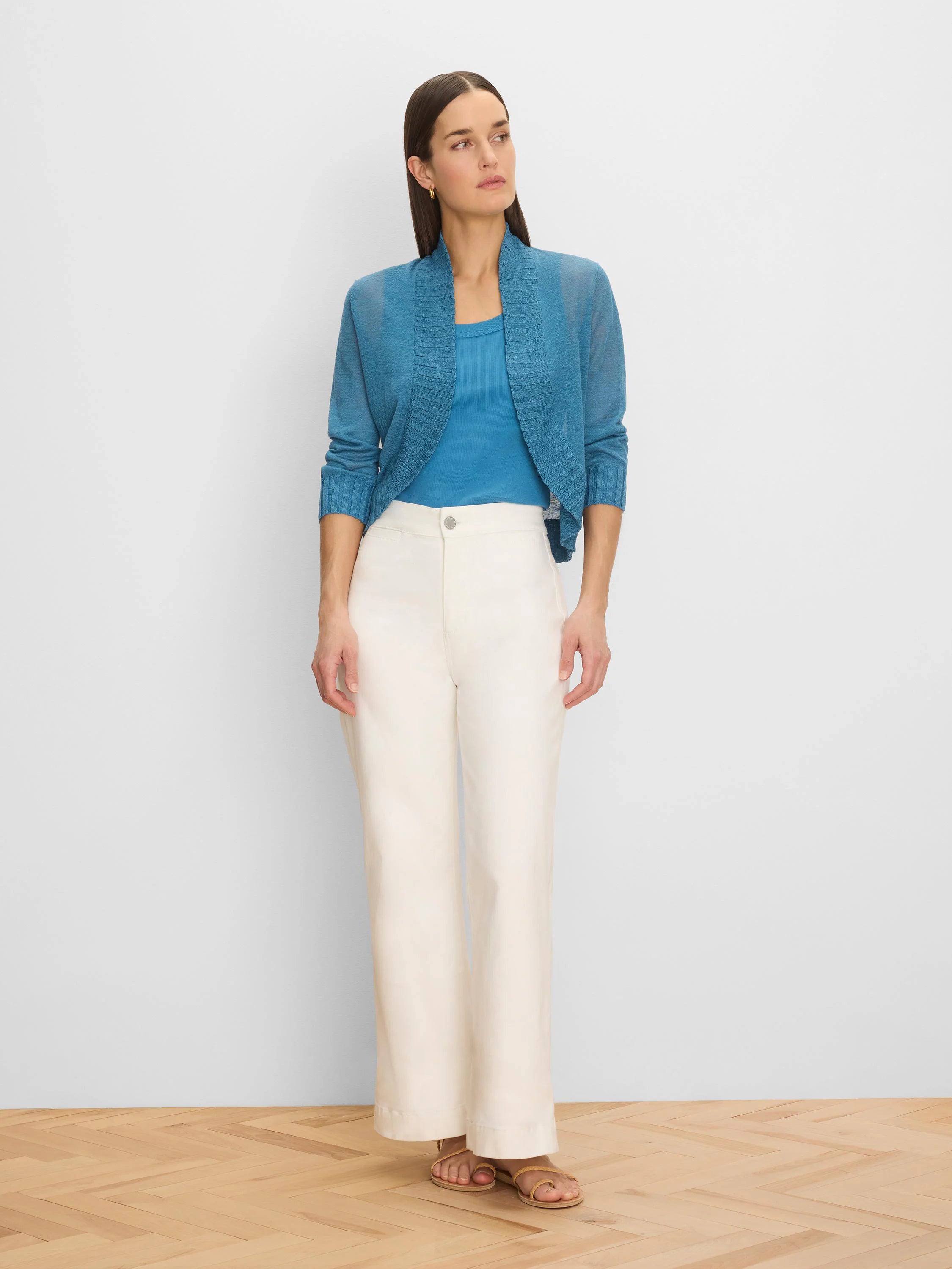 Teal blue open-front bolero cardigan with a ribbed wide collar and ribbed cuffs on its long sleeves.