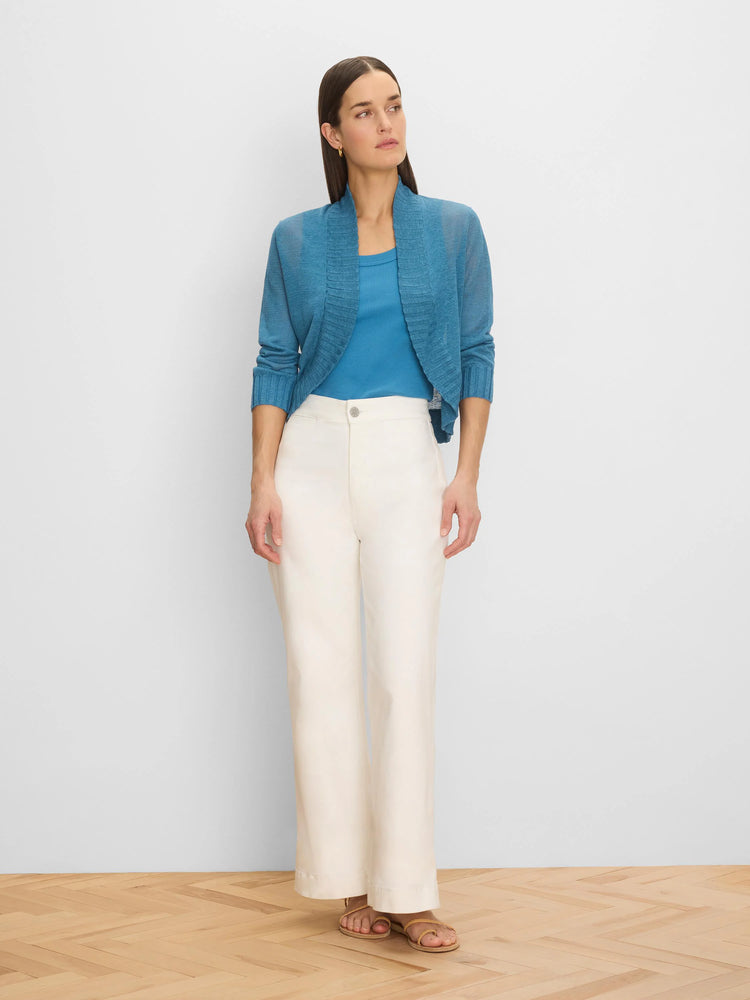 Teal blue open-front bolero cardigan with a ribbed wide collar and ribbed cuffs on its long sleeves.