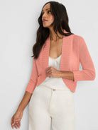 Coral pink bolero cardigan with 3/4 ribbed sleeves and an open front.