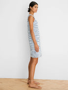 Sleeveless, knee-length dress in blue and white spacedye knit with textured horizontal stripes.