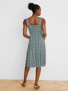 Light teal midi dress with dark blue & light blue abstract vine pattern. Features wide straps & shirred back.