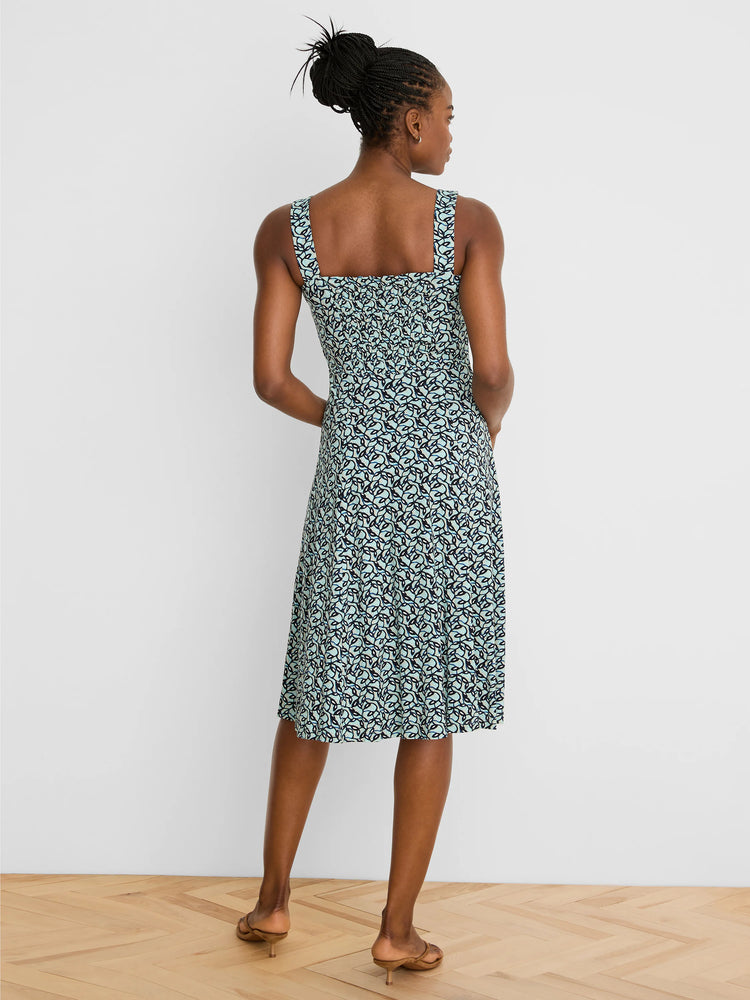 Light teal midi dress with dark blue & light blue abstract vine pattern. Features wide straps & shirred back.