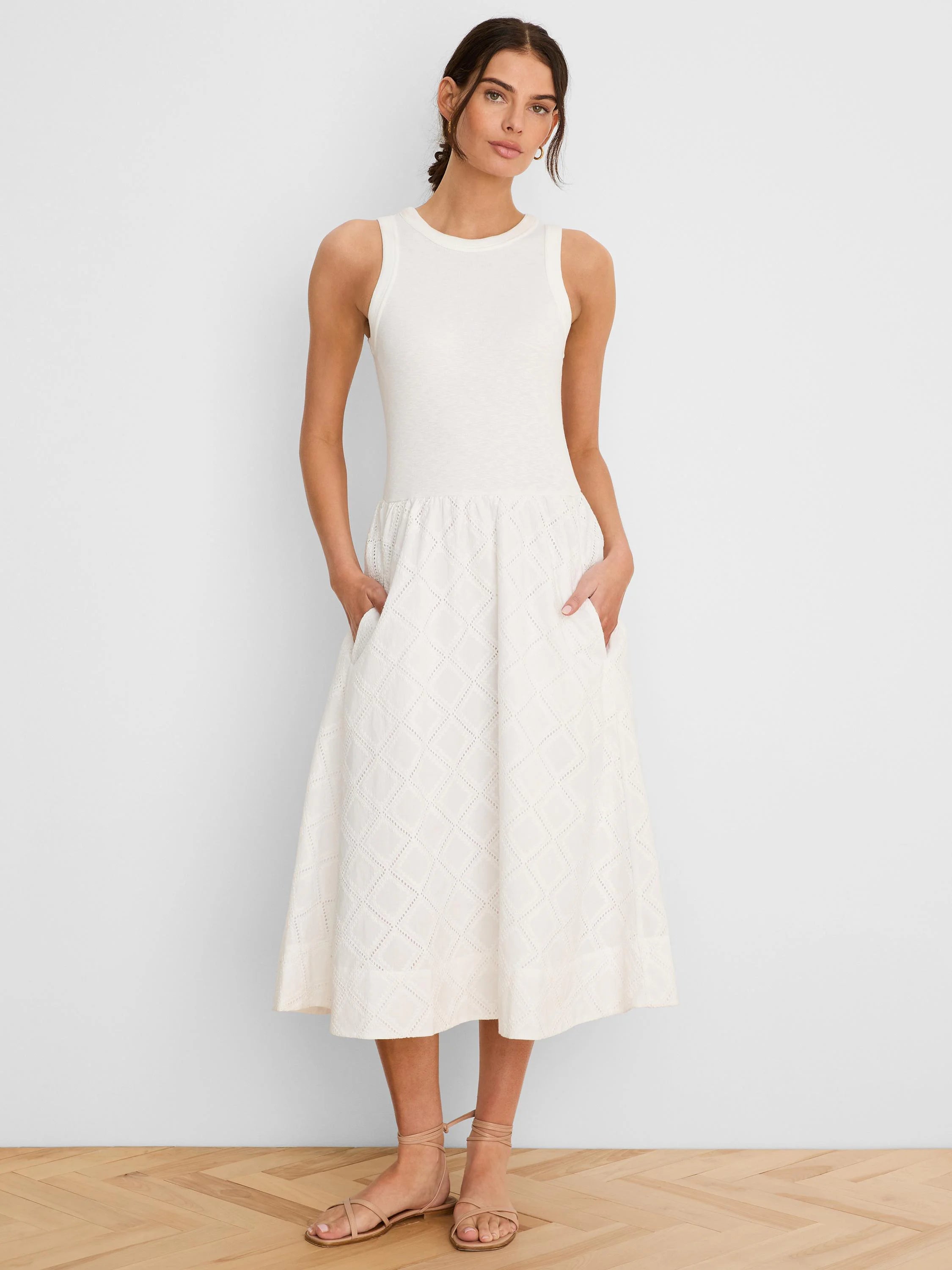 Cream sleeveless dress with a ribbed tank top and a midi skirt featuring a diamond eyelet pattern.