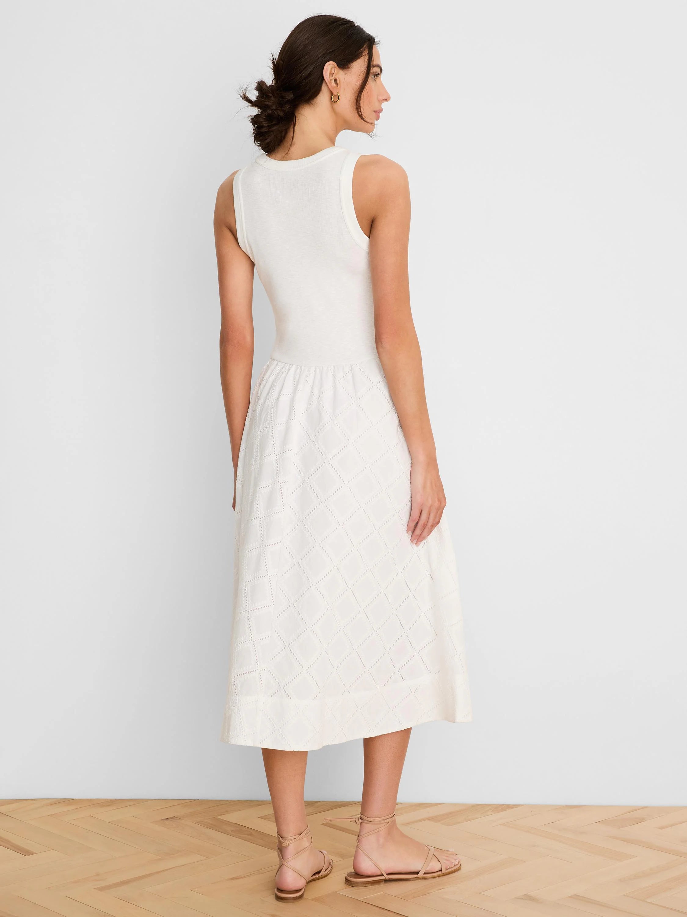 Off-white sleeveless midi dress with ribbed knit top and flared skirt featuring a diamond eyelet pattern.