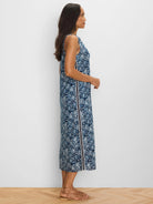 Dark blue & white patterned sleeveless midi dress with a straight cut. Features a dark vertical side stripe bordered by...