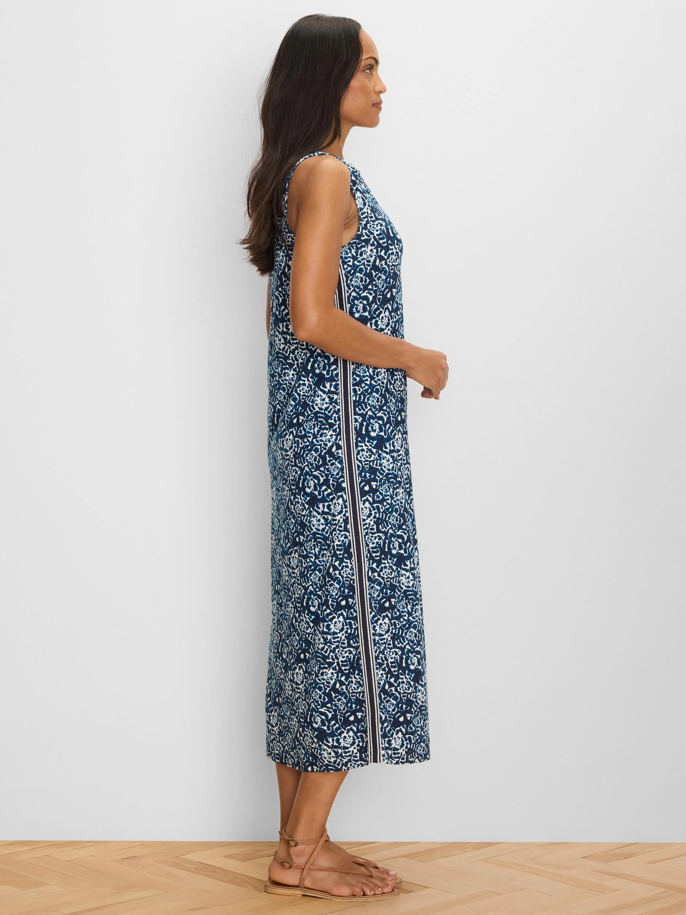 Dark blue & white patterned sleeveless midi dress with a straight cut. Features a dark vertical side stripe bordered by...